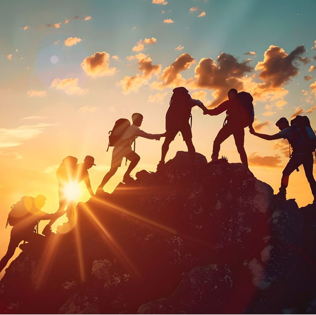 6 people helping eah other to climb up the mountain together during sunrise